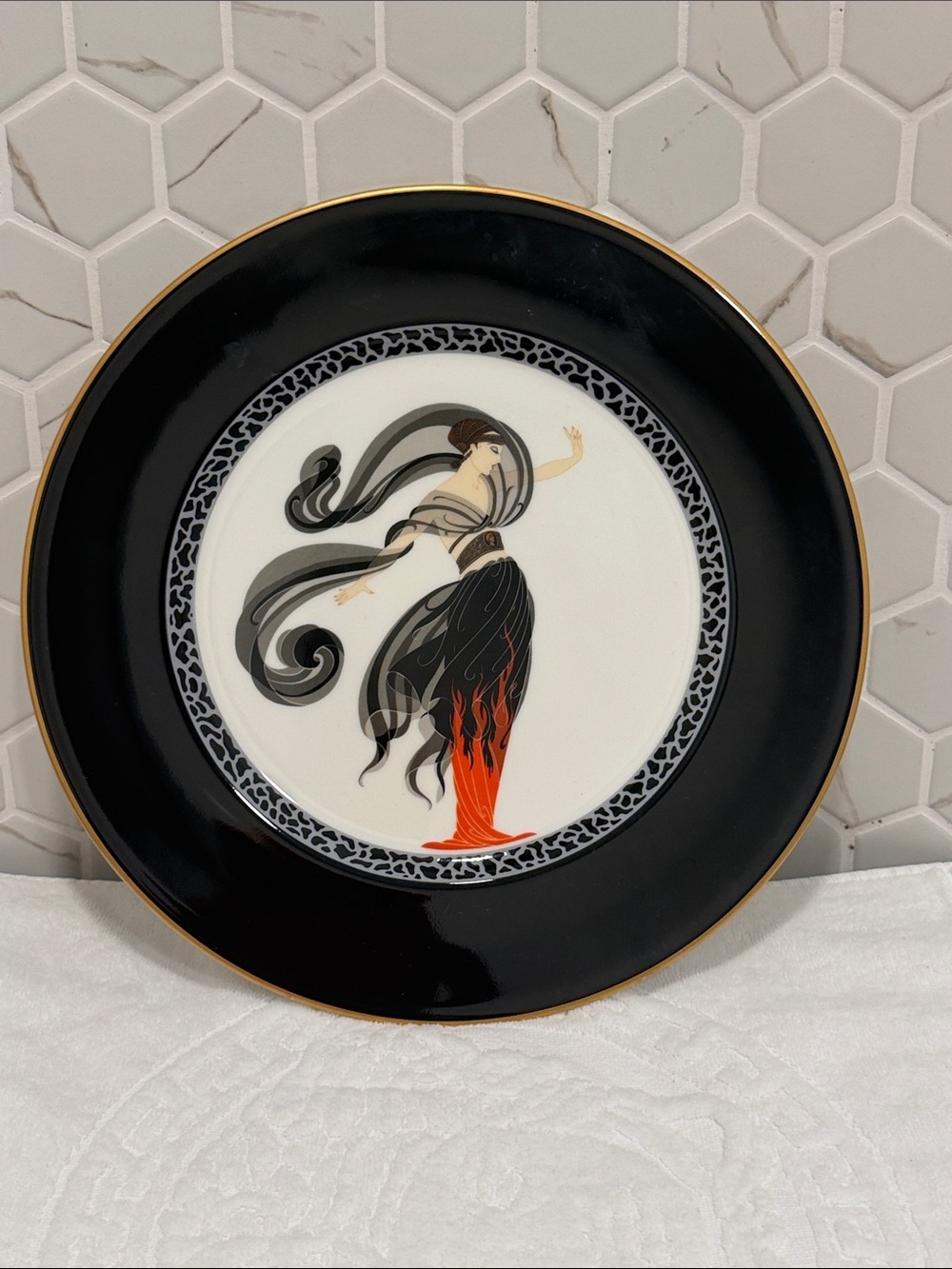 Black and White Decorative Plate with Orange Accent Figure
